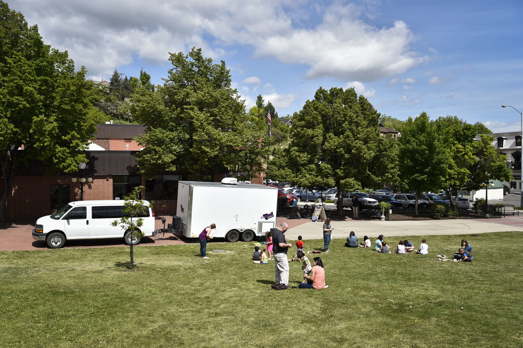 People gather on the lawn outside the Lewis and Clark Library
